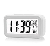 White digital alarm clock with large black time and date display