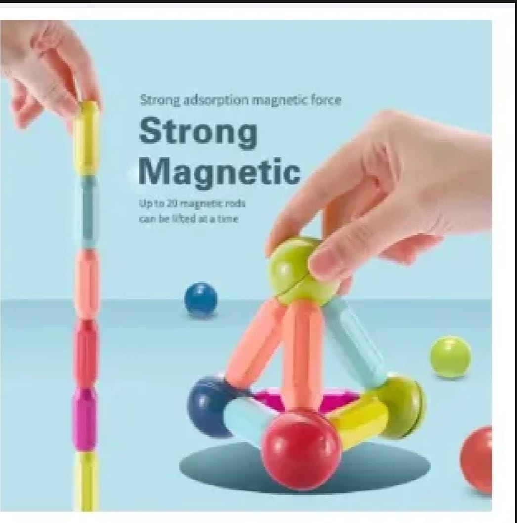 Colorful magnetic rods with ball ends, hands connecting sticks