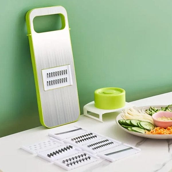 White and green manual food grater with multiple interchangeable blade inserts